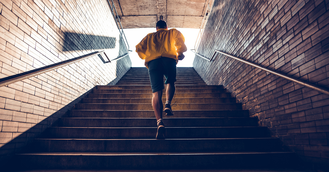 A man runs up a stairway