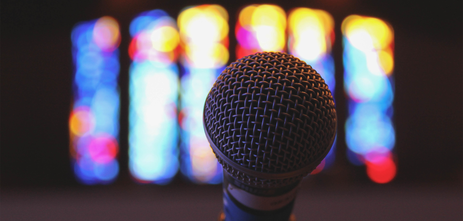 Dr. David Goatley being installed as president of Fuller Theological Seminary in January 2023 Image of a microphone with a stained glass window in the background