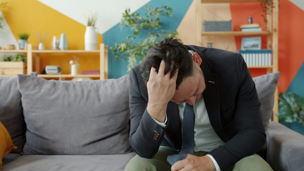 Two people climb up a snow-covered mountain