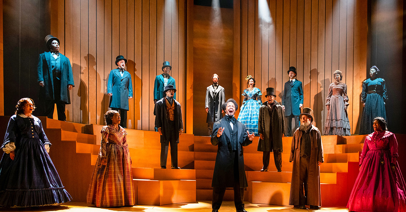 Image of actors on a stage playing Frederick Douglass and his contemporaries
