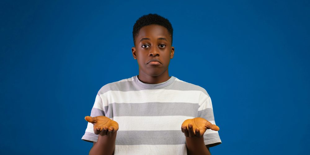 Picture of a young man with his palms up in a kind of shrug