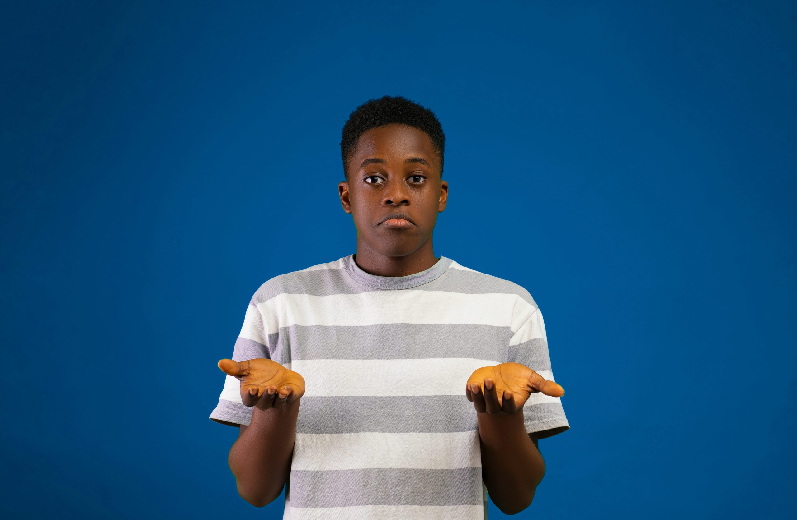 Picture of a young man with his palms up in a kind of shrug