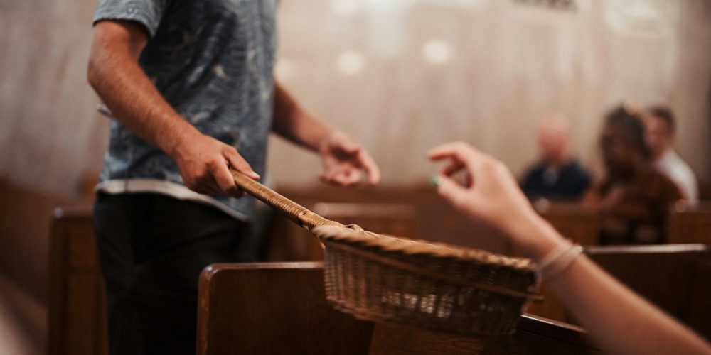 Person passing the offering basket in church
